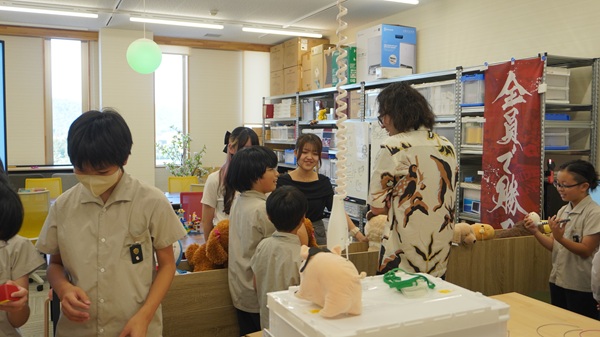 鈴木優准教授、学生と交流する児童たち